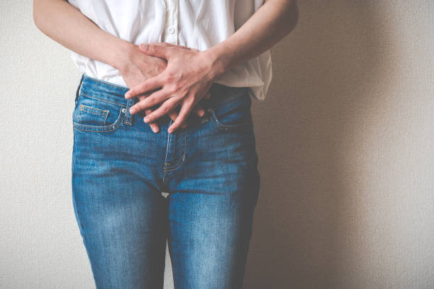 Women touching lower abdomen